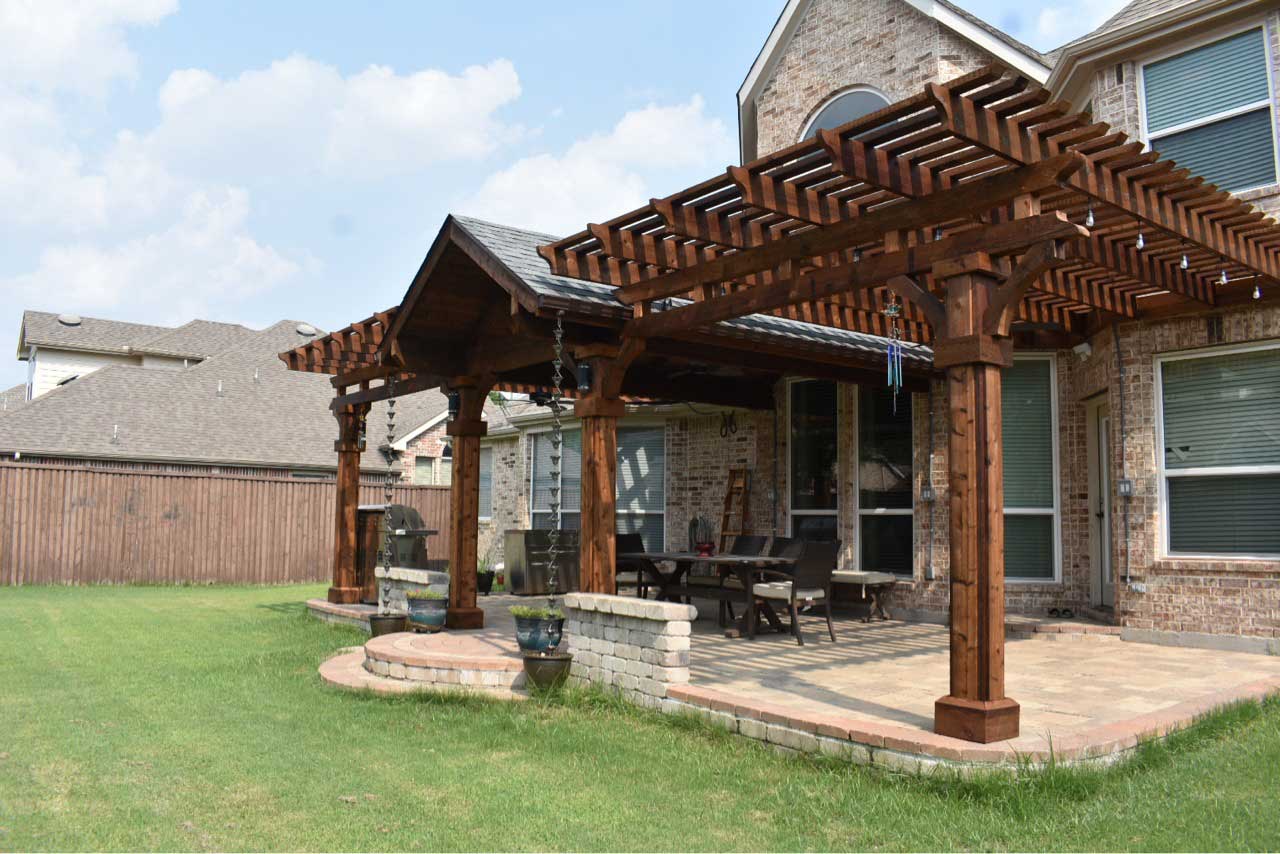 Custom pergola shading a back patio and seating area at a Houston home