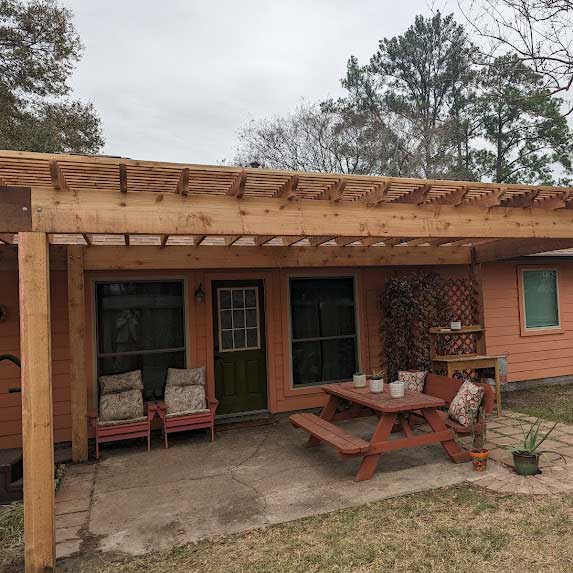 Cedar pergola over a patio with a picnic table
