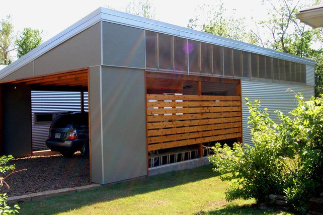 Modern metal carport with a slatted wood screen beside a parked car