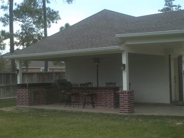 Patio cover over a brick outdoor kitchen with bar seating