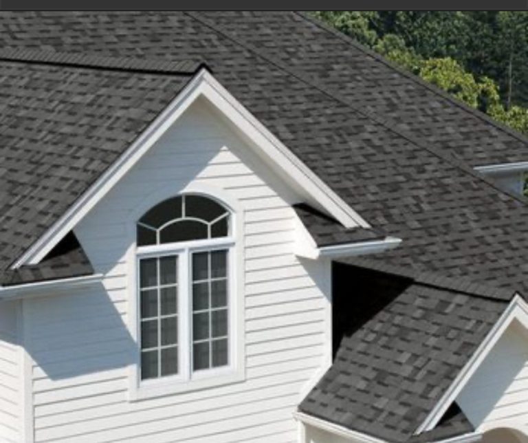 New shingles across a gable and dormer above an arched window