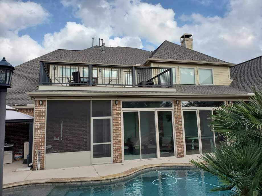 Screened patio enclosure with aluminum framing on the back of a Houston home