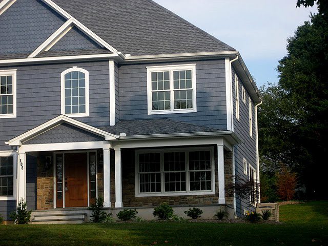 Slate blue house with white trim and a covered front porch