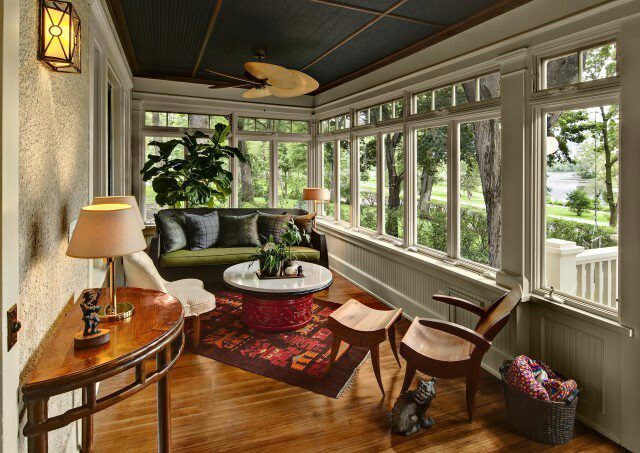 Bright sunroom with glass walls added to the back of a Houston home