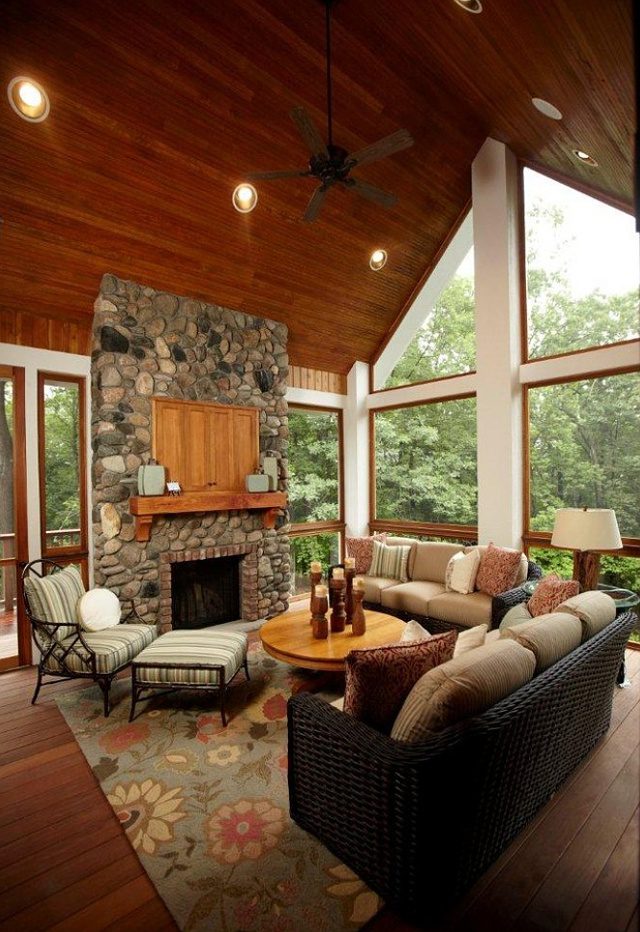 Sunroom with a stone fireplace, a wood ceiling and a ceiling fan