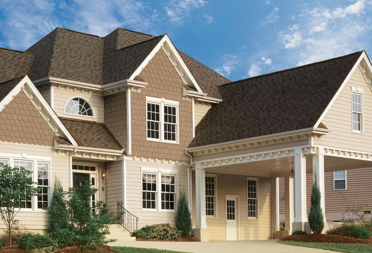 Two story home with lap siding and shingle style accents on the gables