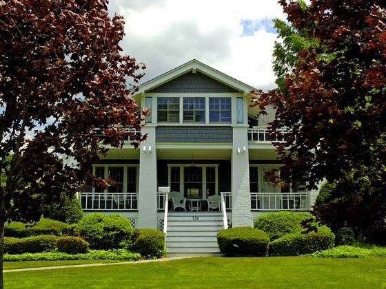Teal lap siding with white trim on a one story craftsman