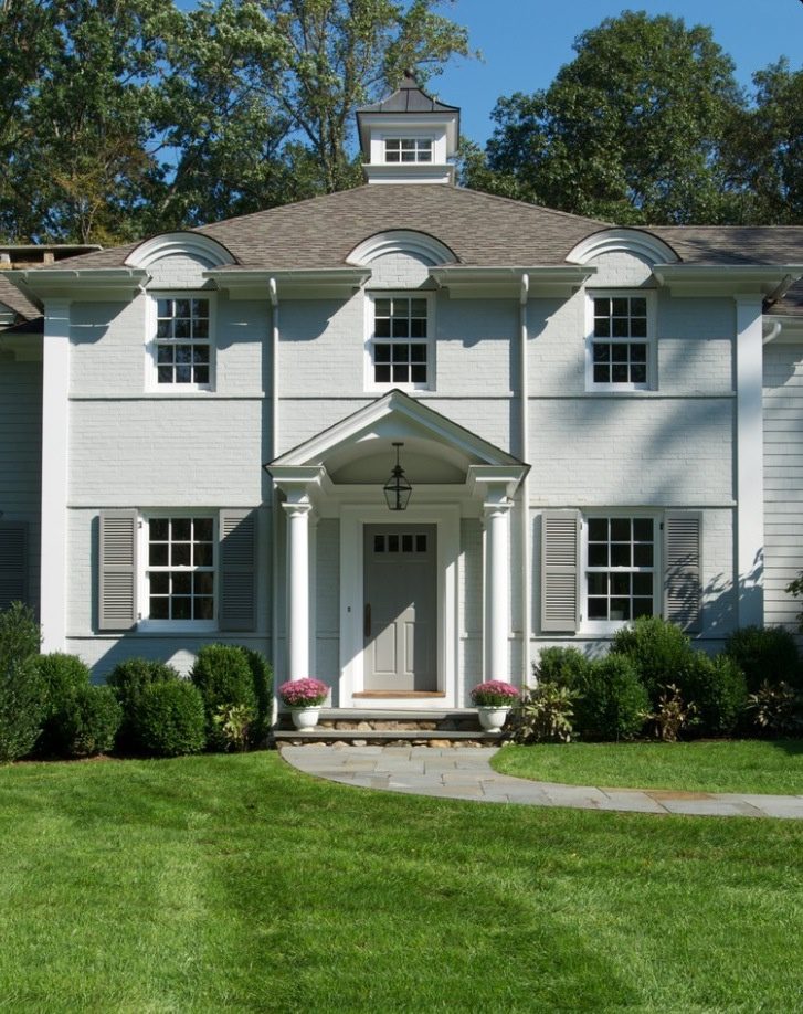 White two story colonial home with gray shutters