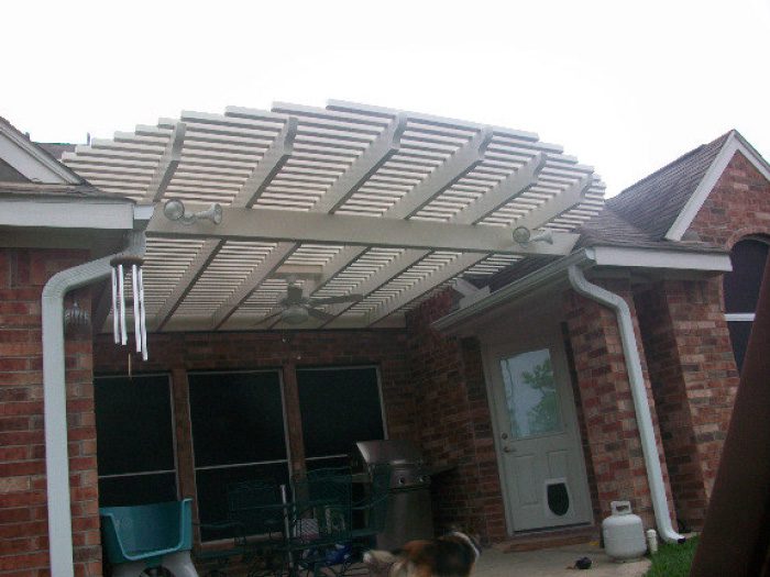Custom built pergola attached to the back of a house
